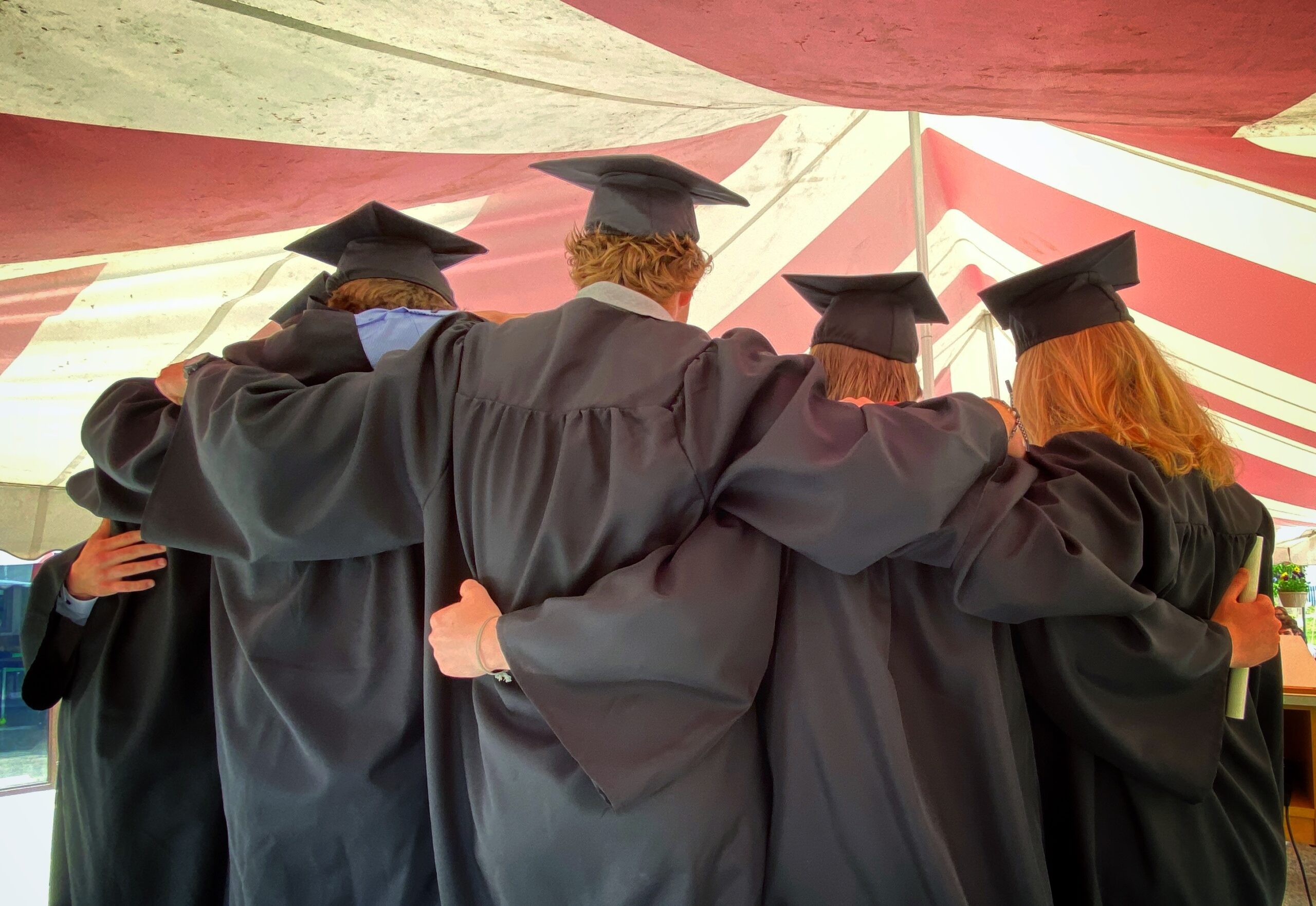 PRI Graduates holding each other