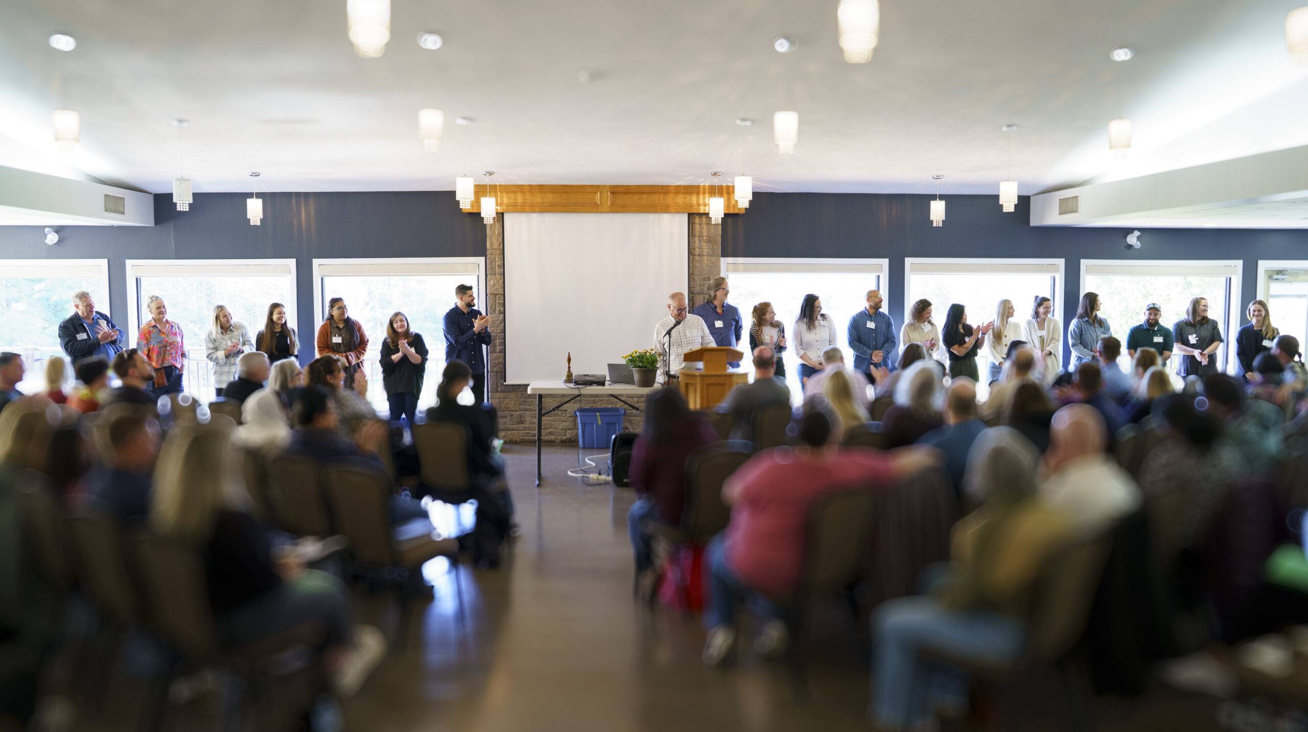 Clinical staff member leading a parent workshop at Pine River Institute, with caregivers gathered in a large group as part of Parallel Process.